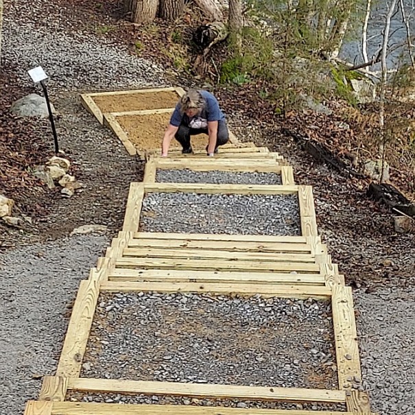 Steps Completed and Allison putting the finishing layer of Tennessee crushed river rock.