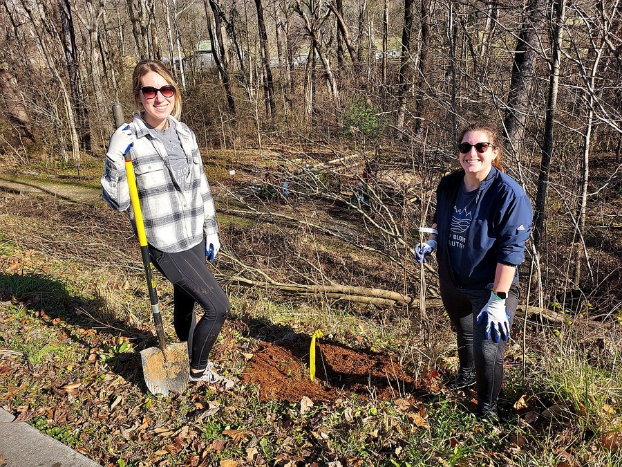 Brittney Whipple (Executive Director) and Michelle De Franco of Keep Blount Beautiful Planting Sassafras Trees at the Townsend River Walk & Arboretum.