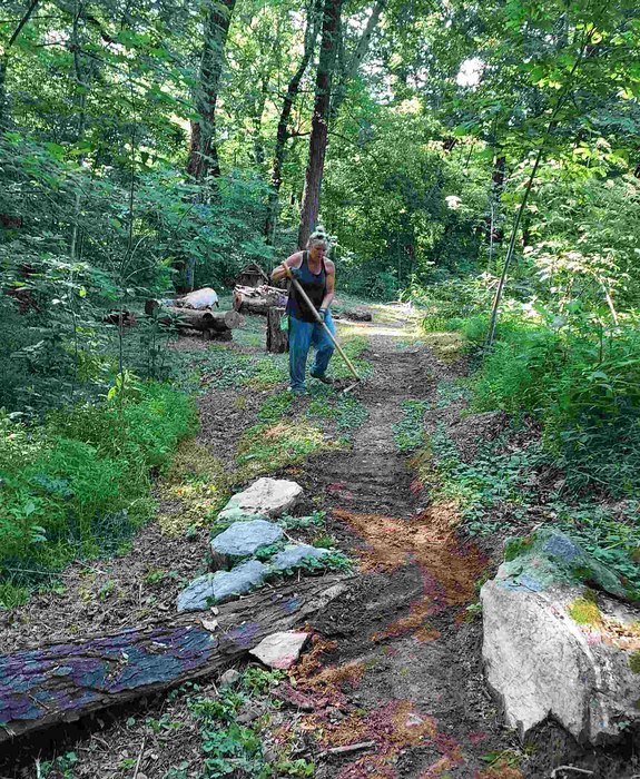 Allison clearing the back path to the Future Children's Discovery Garden.  Story telling logs and an additional Faerie Village have already been installed.